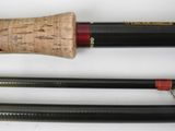 two different types of fishing rods on a white surface