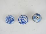three small blue and white plates with designs on them on a white surface