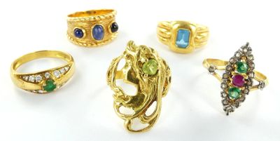 several rings and rings with different colored stones on a white surface