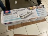 packaging of a wrapmaster machine sitting on top of a cardboard box