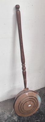 a brown shower head next to a wooden shower head