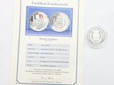 un certificat pour une pièce de monnaie sur laquelle figure l'effigie d'un homme
