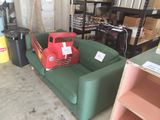 a green couch with a red truck on top of it