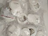 a lot of white electronic devices wrapped in plastic on a table