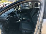 the interior of a car with the door open and the driver ' s seat down