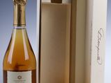 a bottle of wine in a box next to a bottle of wine