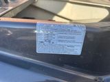 a sticker on the hood of a car that is parked in a parking lot