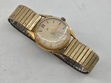 an image of a gold and silver wrist watch on a white surface