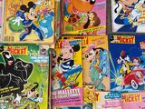 a lot of mickey mouse books on the floor