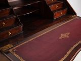 a desk with drawers and a rug on top of it