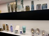 many different types of skin care products displayed on the shelves