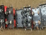 a group of old fashioned train engines sitting on the ground