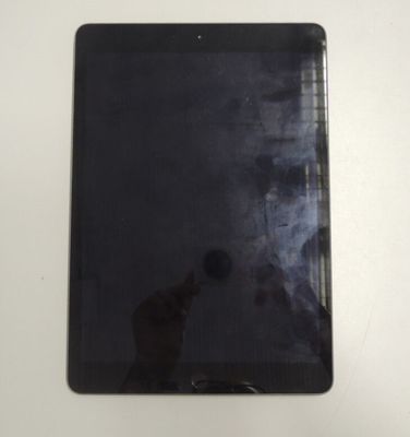 a black tablet computer sitting on a white table
