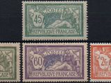 a group of four different colored stamps on a black surface