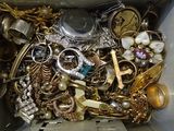 a box filled with lots of gold and silver jewelry