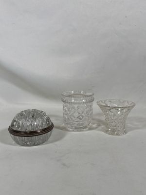 trois objets en verre posés sur une surface blanche
