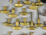 a lot of gold objects on a white table