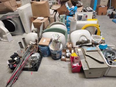 a pile of assorted items on the floor in a warehouse