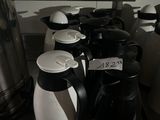 bottles of coffee are lined up on a counter in a kitchen