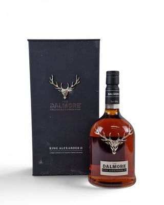 a bottle of dalmore single malt whisky next to a black box