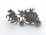 a close up of a silver broochle with a horse and carriage
