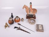 various items that include a figurine of a man on a horse