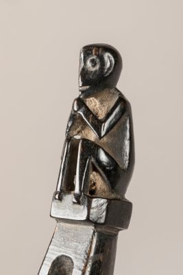 a statue of a monkey sitting on top of a table