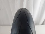 a close up of a motorcycle tire on a white surface