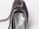 silver purse with a chain on a white background