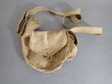 beige leather purse with strap on a gray surface