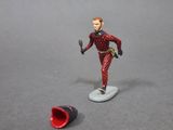 toy figurine of a man on a surfboard next to a red object