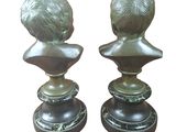 pair of bronze busts of a boy and girl on pedestals