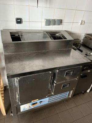 stainless steel counter top in a commercial kitchen with two sinks