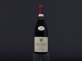 a bottle of wine sitting on top of a wooden table