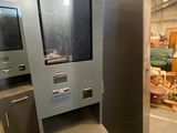 a metal cabinet with a glass door in a warehouse