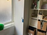 a refrigerator in a room with boxes and boxes on the floor
