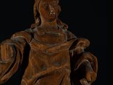 carved wooden statue of a woman holding a basket and a ball