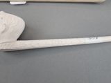 a pipe and a pipe holder sitting on a table