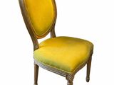 une image représentant une chaise en bois dont l'assise est recouverte d'un tissu jaune