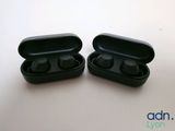 pair of black earphones sitting on top of each other on a table