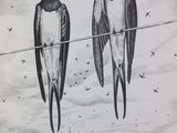 two birds that are sitting on a wire in the sky