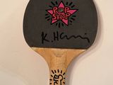 a ping pong paddle with a pink star on it