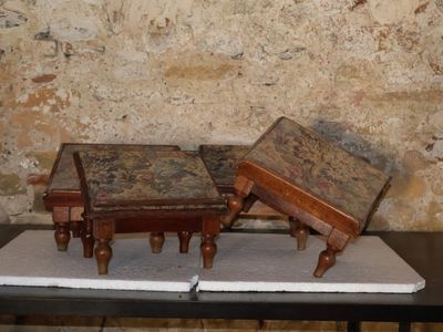 two small tables on a table in front of a brick wall
