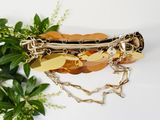 a gold bracelet with a leaf and a star on it