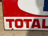 a red and white sign with the word total on it