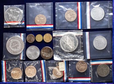 a lot of coins that are in a blue case