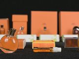 many bottles of perfume sitting on a black table