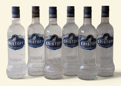 six bottles of water are lined up in a row