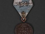 an old medal with a picture of a plane on it