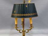 an antique brass table lamp with a blue shade and gold trim